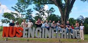 Student Group in front of sign.